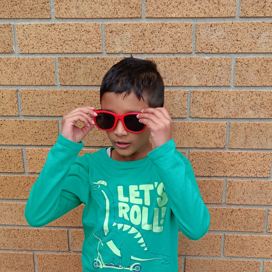 Child wearing Wai Classic Red Black kids sunglasses NZ — Te Rā