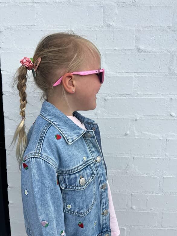 Child wearing Māhanga Flamingo Pink cat-eye sunglasses NZ — Te Rā