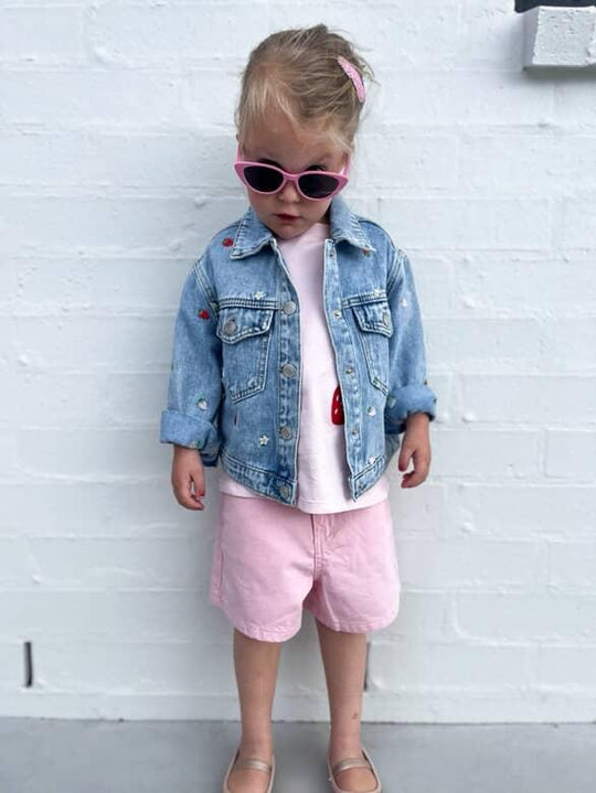 Child wearing Māhanga Flamingo Pink cat-eye sunglasses NZ — Te Rā