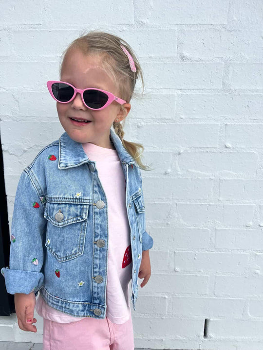 Child wearing Māhanga Flamingo Pink cat-eye sunglasses NZ — Te Rā