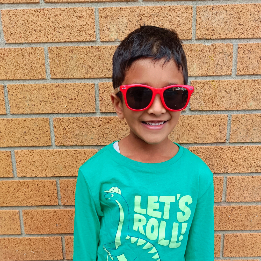 Child wearing Wai Classic Red Black kids sunglasses NZ — Te Rā